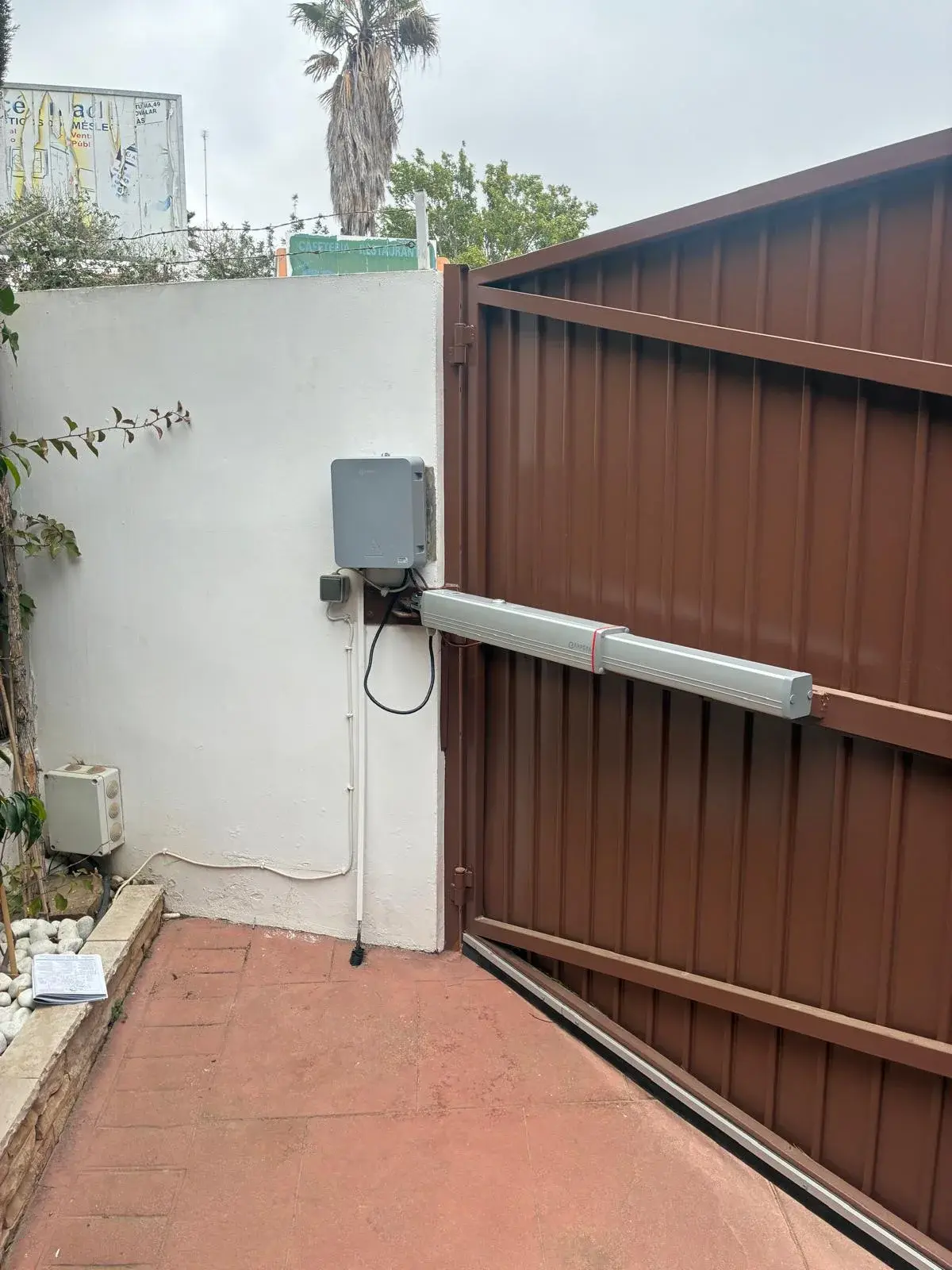 Motor hidráulico instalado en una puerta batiente de chalet.